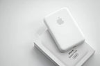 Portable 5000mAh MagSafe battery pack attached to iPhone 14